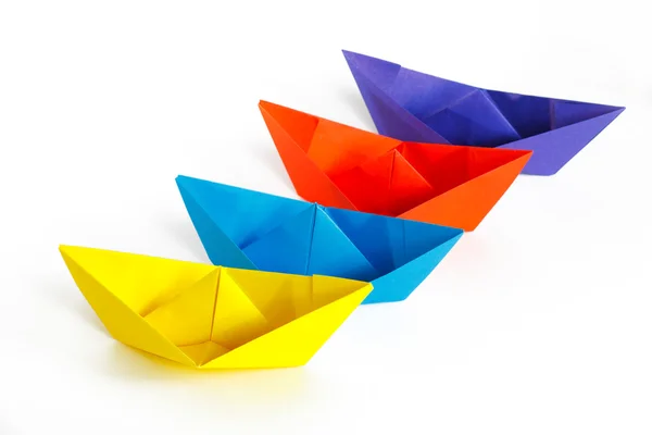 Four colored paper ship on a white background — Stock Photo, Image