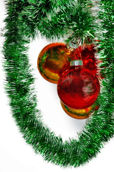 Christmas balls on a green tinsel as a symbol of the New year — Stock Photo, Image