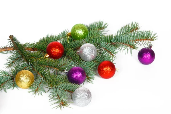 Many colored balls on the fir branch of Christmas tree — Stock Photo, Image