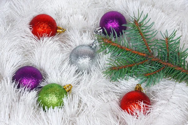 Christmas wreath of tinsel and colored balls with pine branch — Stock Photo, Image
