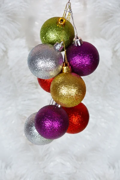 Colored Christmas balls on a white tinsel as a symbol of the New year — Stock Photo, Image