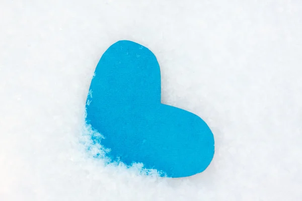One heart shape from blue paper in the snow for Valentines day — Stock Photo, Image