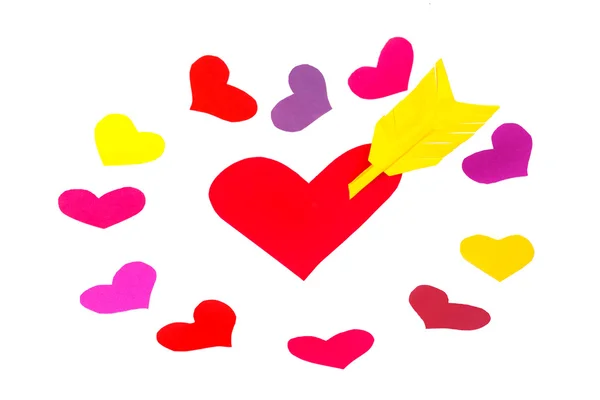 One red paper heart shape with arrow and many little colored heart shapes — Stock Photo, Image