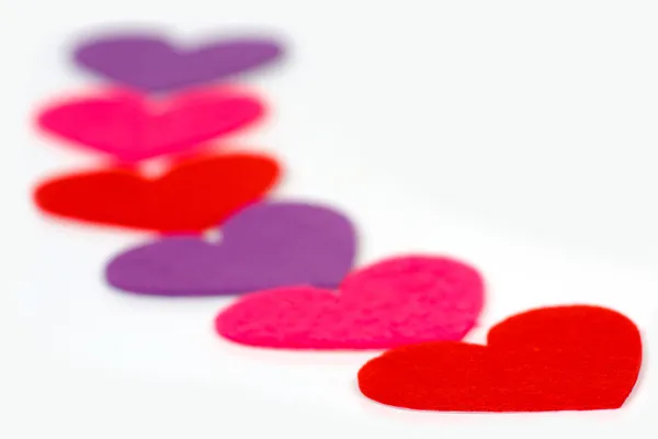 Many colored heart shapes in a row — Stock Photo, Image