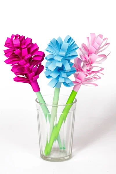 Bouquet of colored paper flowers in the faceted glass — Stock Photo, Image