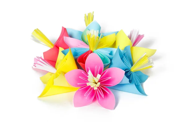 Seven colored paper flowers and flower with varicolored petals — Stock Photo, Image