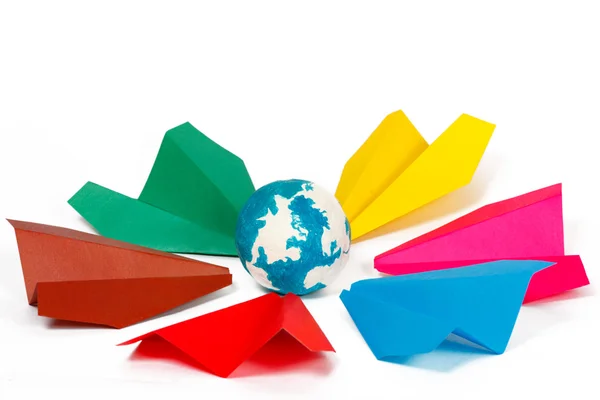 Many colored paper planes and paper globe — Stock Photo, Image