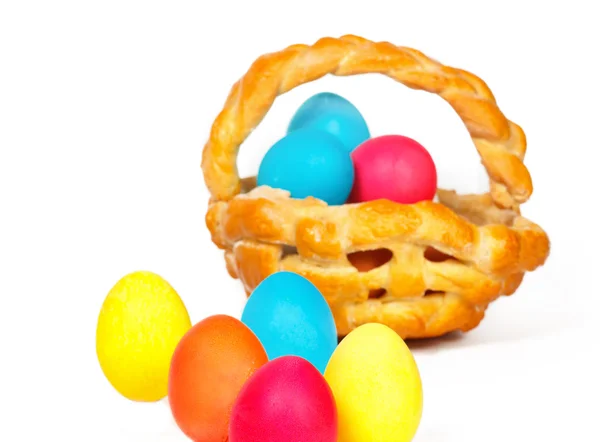 Baked basket with Easter colored eggs — Stock Photo, Image