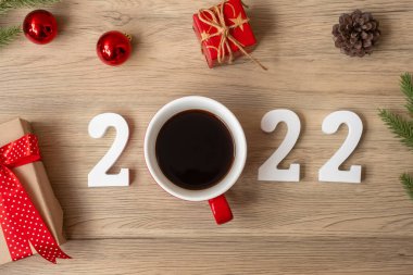 2022 Mutlu Yıllar. Kahve fincanı ve ahşap masa altyapısı ile Noel süslemesi. Yeni Başlangıç, Çözünürlük, Geri sayım, Hedefler, Plan, Eylem ve Görev Konsepti