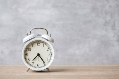 Ahşap masa arkaplanındaki klasik alarm saati ve metin için kopyalama alanı. Etkinlik, günlük rutin, sabah, geri sayım, egzersiz ve iş hayatı dengesi kavramı