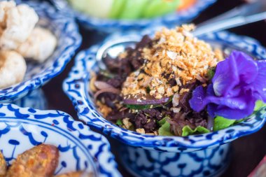 traditional Thai food on bamboo tray or Khan Toke, local food in Northern of Thailand