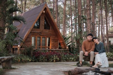 Couple tourist traveling in pine tree forest, Man and Woman visit at Doi Bo Luang, Chiang Mai, Thailand, Landmark and popular for tourist attractions. Together, Vacation and journey concept
