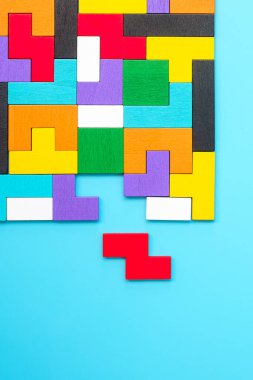 Mavi arka planda renkli ahşap yapboz parçaları, geometrik şekil bloğu. Mantıksal düşünme kavramları, Conundrum, çözümler, rasyonel, strateji, dünya mantık günü ve eğitim