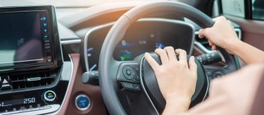 woman driver honking a car during driving on traffic road, hand controlling steering wheel in vehicle. Journey, trip and safety Transportation concepts