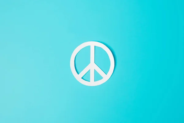 International Day of Peace. white paper Peace symbol on blue background. Freedom, Hope, World Peace day 21 September and Nuclear Disarmament concepts..