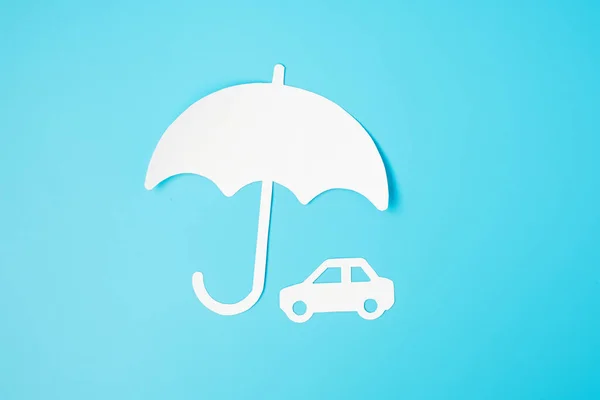 Umbrella cover Car paper on blue background. Warranty, Maintenance, Vehicle and insurance concept