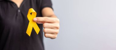 Suicide prevention day, Childhood, Sarcoma, bone and bladder cancer Awareness month, Yellow Ribbon for supporting people life and illness. children Healthcare and World cancer day concept