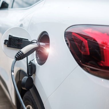 Electric car charging battery at EV charger station or home. green energy power, Eco friendly alternative, technology and environment concepts