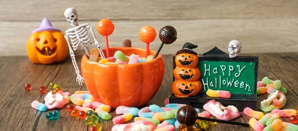 Happy Halloween day with ghost candies, pumpkin bowl, Jack O lantern and decorative (selective focus). Trick or Threat, Hello October, fall autumn, Festive, party and holiday concept