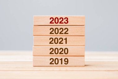 2023 block over 2022 and 2021 wooden building on table background. Business planning, Risk Management, Resolution, strategy, solution, goal, New Year New You and happy holiday concepts
