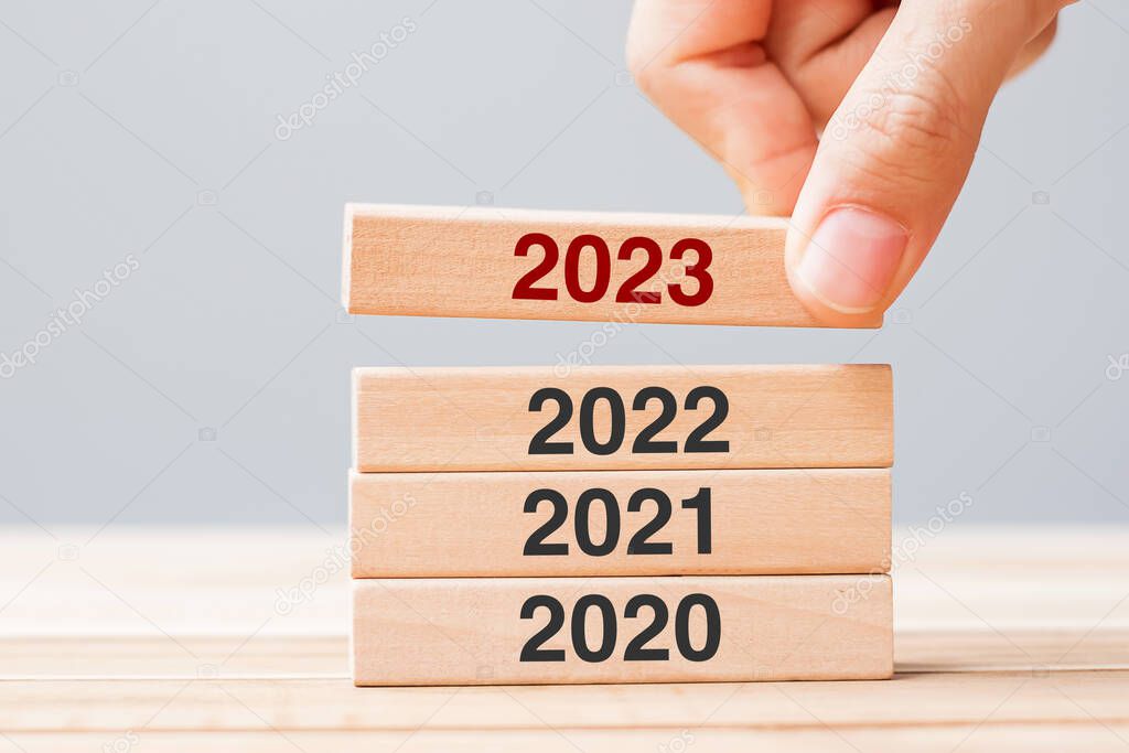 2023 block over 2022 and 2021 wooden building on table background. Business planning, Risk Management, Resolution, strategy, solution, goal, New Year New You and happy holiday concepts