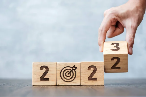 hand flip 2022 to 2023 block with dartboard sign. Business Goal, Target, Resolution, strategy, plan, Action motivation, change, thinking, countdown and New Year start concepts