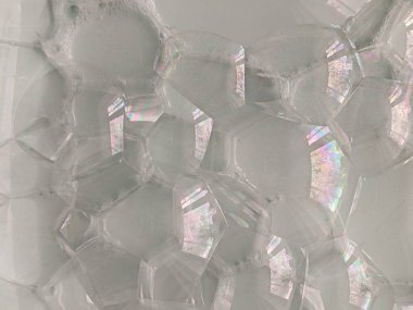 Abstract blurred background.Large huge bright soap bubbles against the background of the sky and trees. Soap bubbles show.