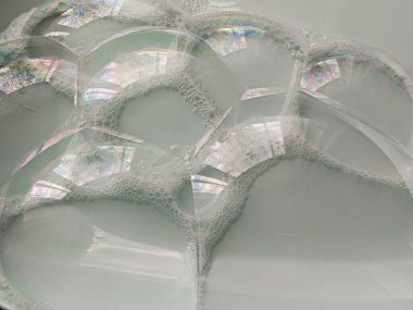 Abstract blurred background.Large huge bright soap bubbles against the background of the sky and trees. Soap bubbles show.