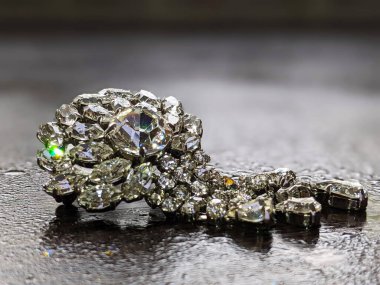Silver brooch in the shape of a flower decorated with brilliant stones
