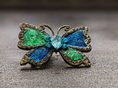 Beautiful decorative brooch in the form of a butterfly with enamel close up