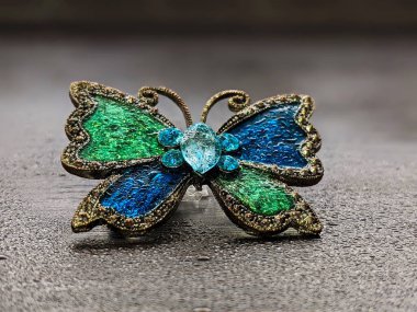 Beautiful decorative brooch in the form of a butterfly with enamel close up