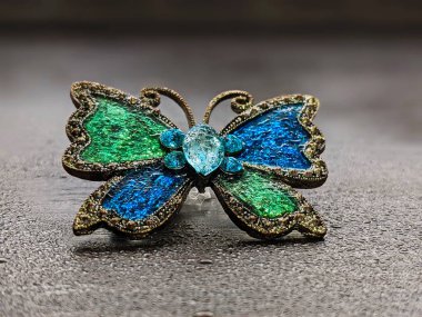 Beautiful decorative brooch in the form of a butterfly with enamel close up