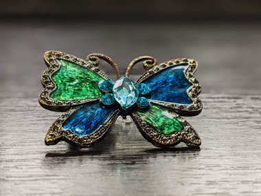 Beautiful decorative brooch in the form of a butterfly with enamel close up