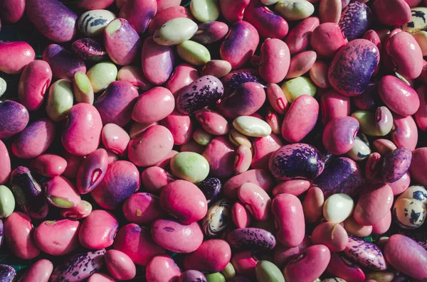 mixed beans pink and green, background close up