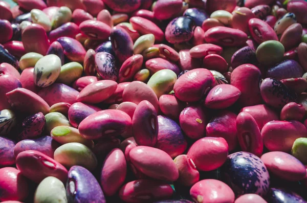 mixed beans pink and green, background close up