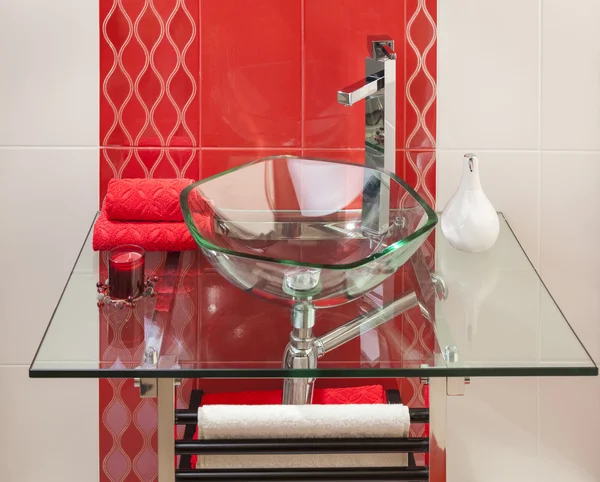 Detail of a modern bathroom interior in pink and white with sink of glass — Stock Photo, Image