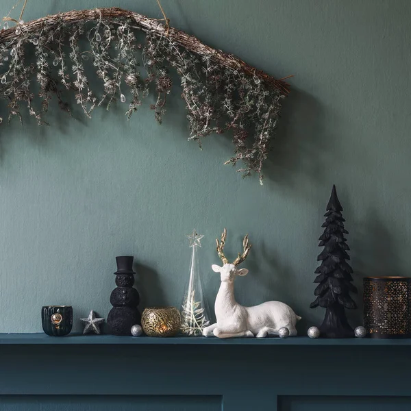 Christmas composition on the shelf in the living room interior. Beautiful decoration. Christmas trees, candles, stars, light and elegant accessories. Merry Christmas and Happy Holidays, Template.