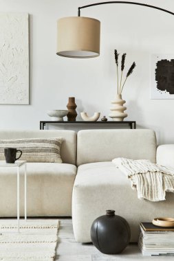 Poster çerçevesi ve yapı boyası, köşedeki kanepe, sehpa, tekstil ve kişisel aksesuarları olan yaratıcı bir iç mekan. İskandinav klasiği.