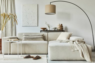 Poster çerçevesi ve yapı boyası, köşe kanepe, sehpa, tekstil ve kişisel aksesuarları olan rahat oturma odasının şık iç tasarım kompozisyonu. İskandinav klasiği.