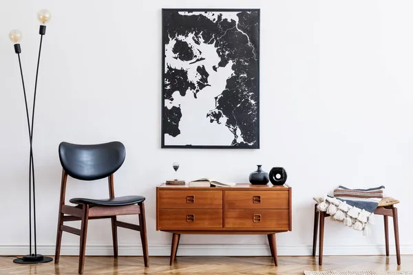 Stylish interior design of living room with wooden retro commode, chair, tropical plant in rattan pot, basket and elegant personal accessories. Mock up poster frame on the wall. Template. Home decor.