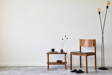 Modern composition of stylish livng room interior with creative vintage chair, side table, modern lamp and elegant personal accessories. Wallpaper. Copy space. Template.  