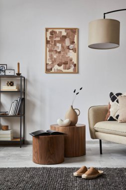 Minimalist interior of elegant living room with mock up poster frame, beige modern sofa, wooden side tables and personal accessories. Creative home staging. Copy space. Template. 
