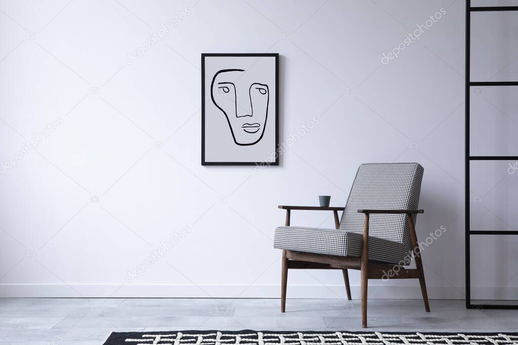 Minimalistic loft interior composition with retro design armchair and mock up poster frame. Copy space. Template