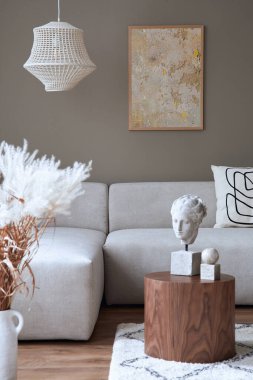 Tasarımsal nötr modüler kanepe, poster çerçeveleri, kahve masaları, kurutulmuş çiçekler, dekorasyon, kolye lambası ve modern ev dekorunda zarif kişisel aksesuarlar. Şablon.