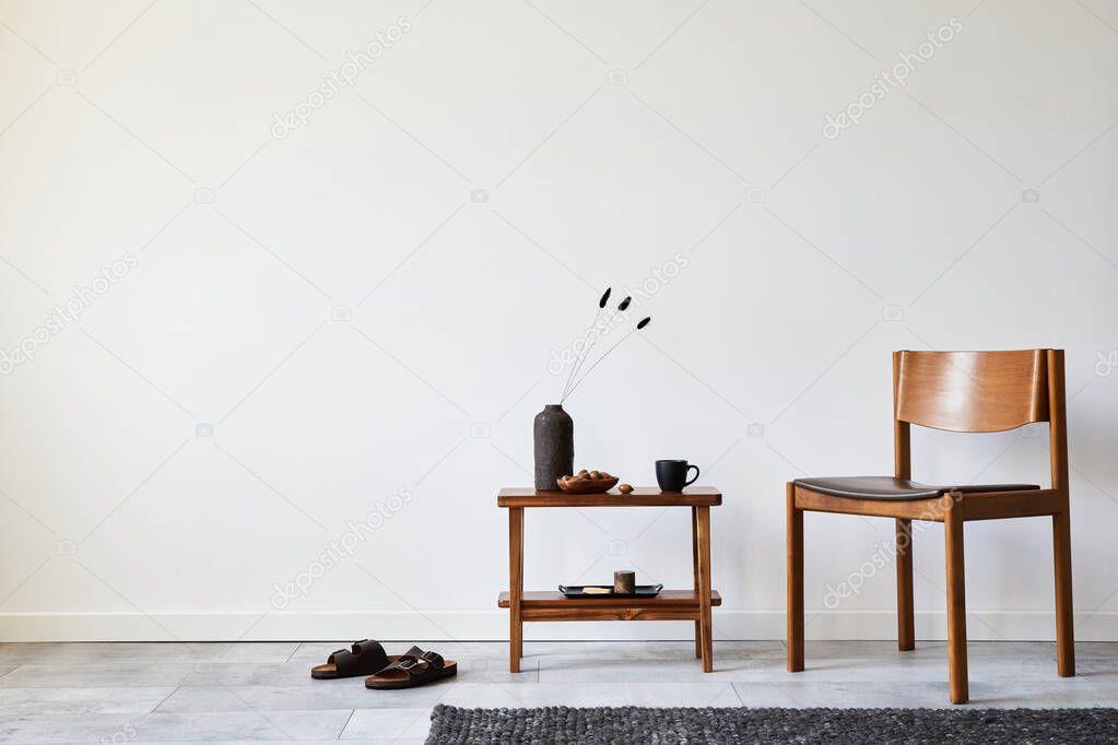 Modern composition of stylish livng room interior with creative vintage chair, side table and elegant personal accessories. Wallpaper. Copy space. Template. 