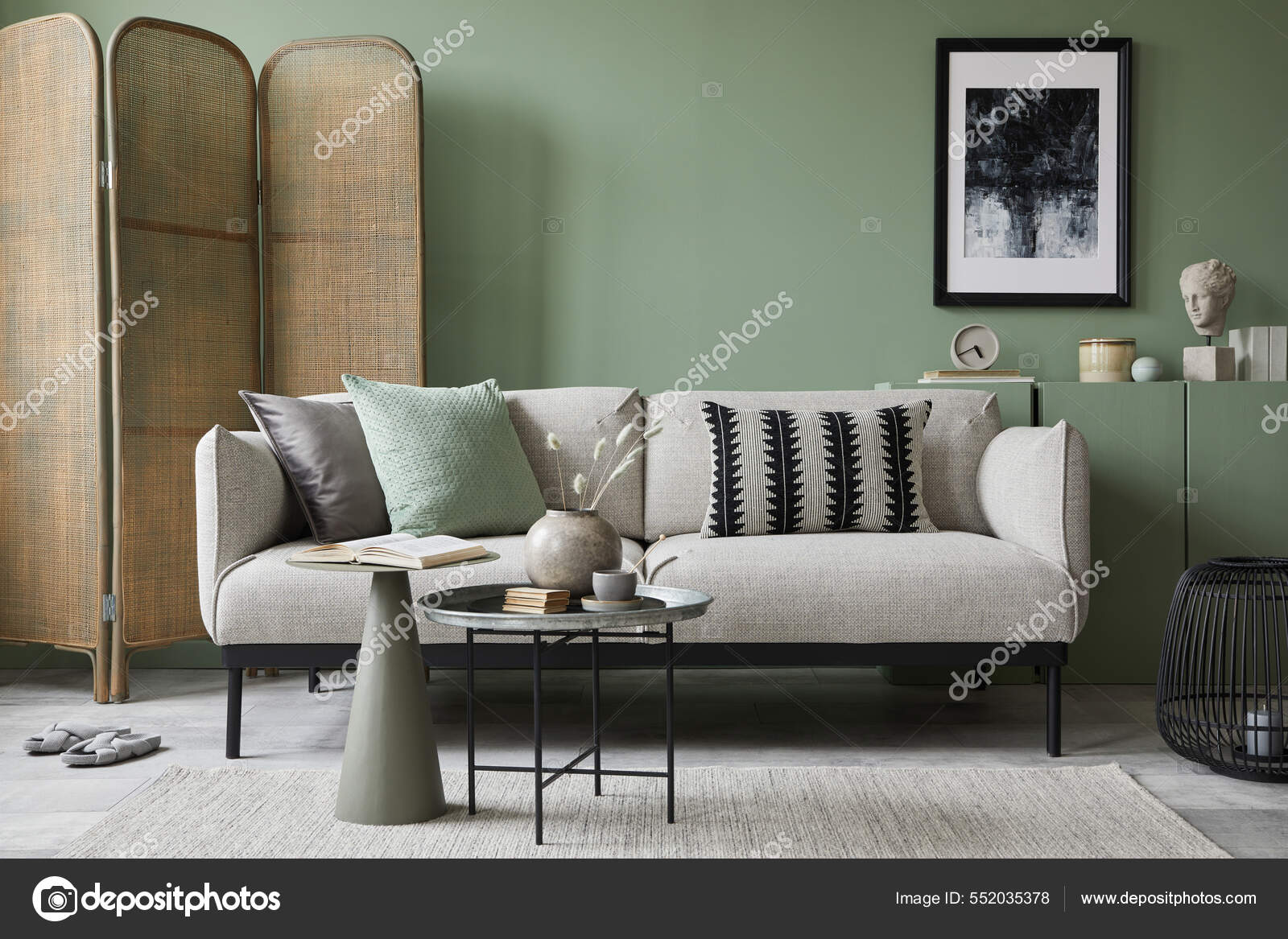 Elegant composition of living room interior. Modern scandi sofa, design  pillows, side table, rattan commode and creative personal accessories. Sage  green wall. Template. Copy space. Stock Photo