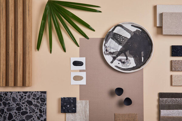 Creative flat lay composition of interior designer and architect moodboard. Textile and paint samples, lamella panels and lastrico tiles. Beige, black and green color palette. Copy space. Template. 