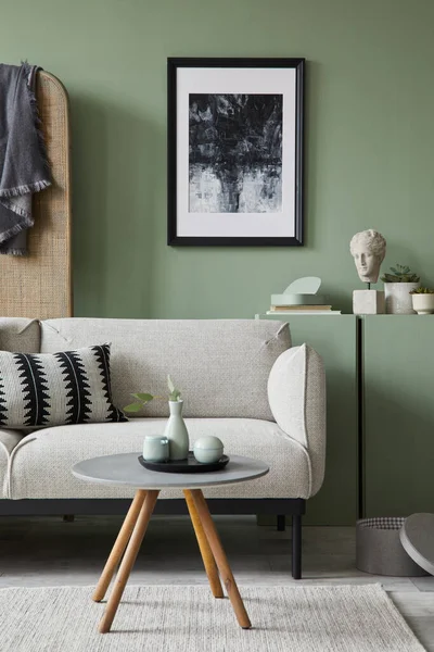 Creative living room interior composition with mockup poster frame, grey modern sofa, folding screen and modern home accessories. Green wall. Home staging. Template. Copy space