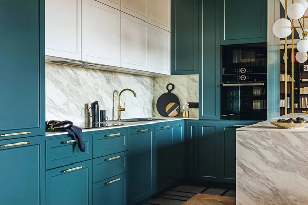 stock image Luxury modern and vintage turquoise and white kitchen. Marble kitchen island with white owal chandelier . Gold tap on marble table top. Template.
