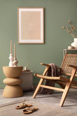 Stylish living room interior design with mock up poster frames, rattan armchair, coffe table, beige carpet and creative home accessories. Sage green wall. Template. 